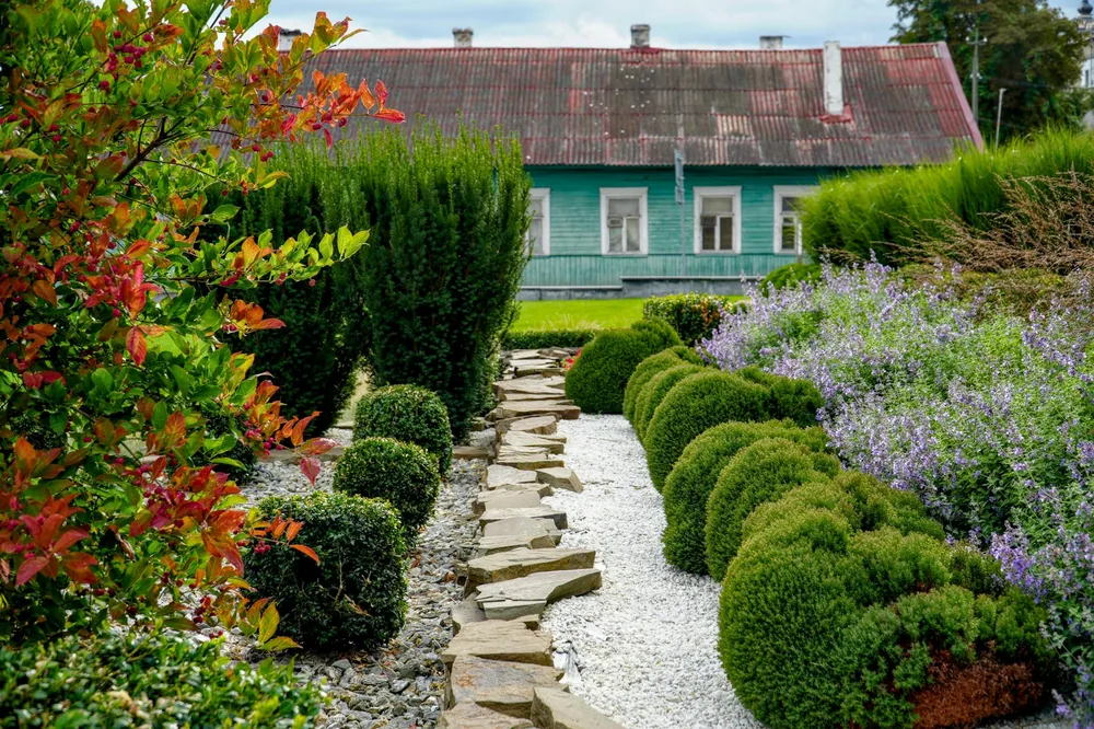 Designed landscape bed with retaining wall and plantings